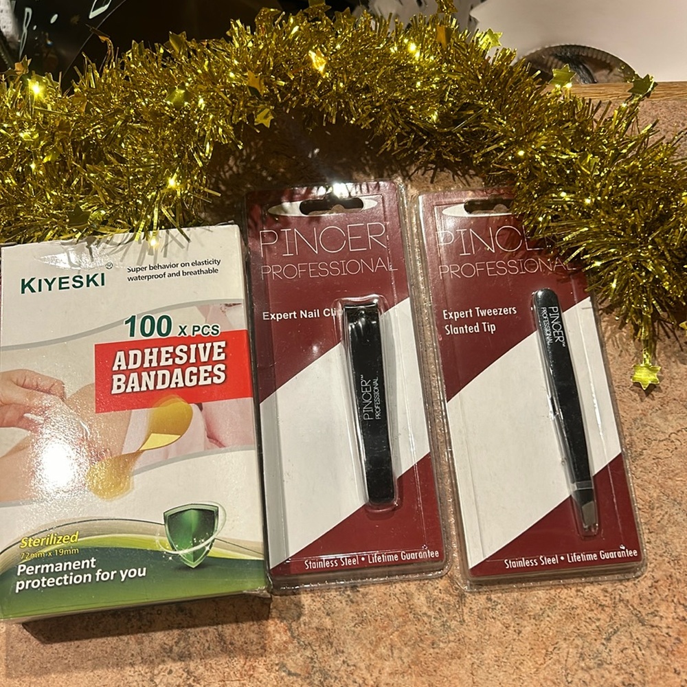 Brand new 100 bandaids, 1 pair of tweezers, 1 nail clippers